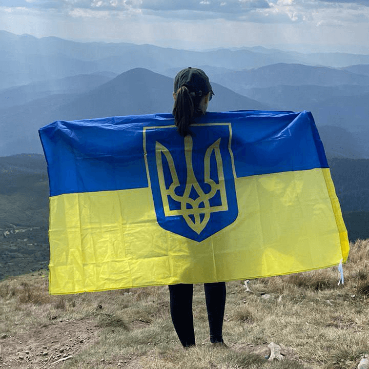 A woman holding a Ukranian flag