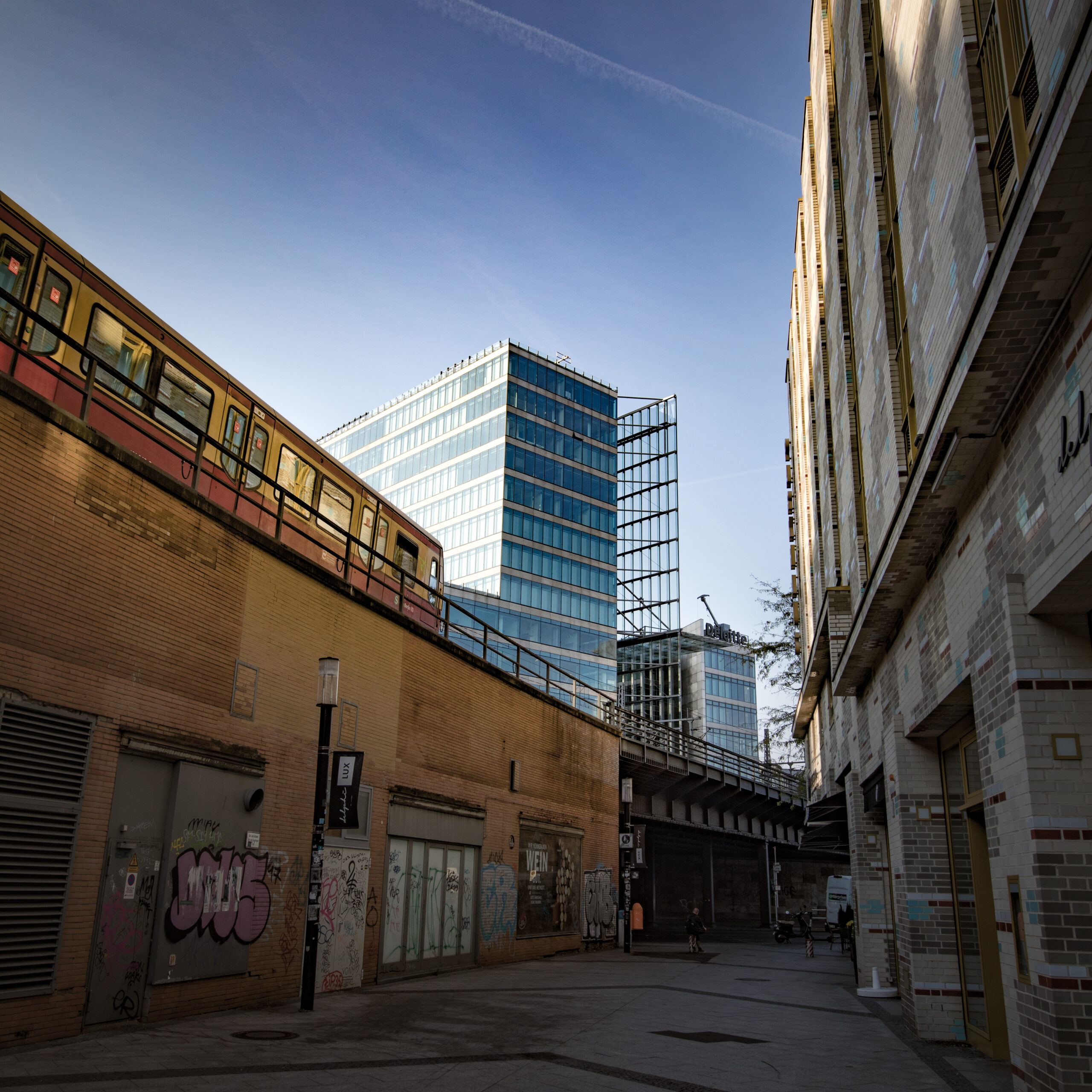 A street with buildings and a train, where Headquarter is located